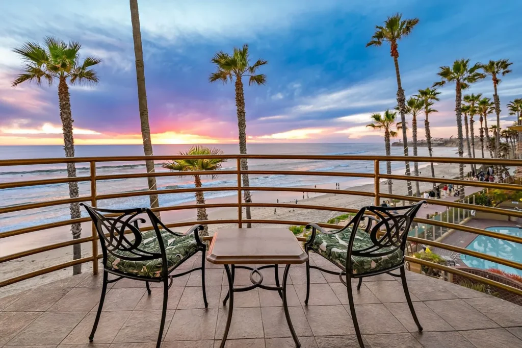 balcony at Pacific Terrace Hotel in San Diego with chairs, table, and calming ocean view in California