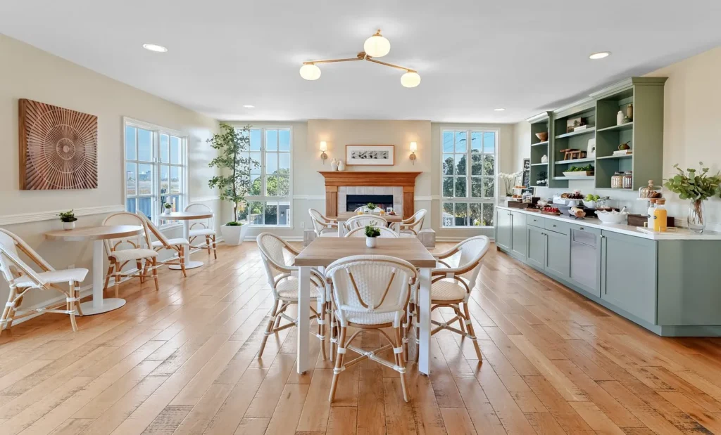 elegant dining room with white chairs and fireplace at Inn at Playa del Rey, a warm California hotel near the beach